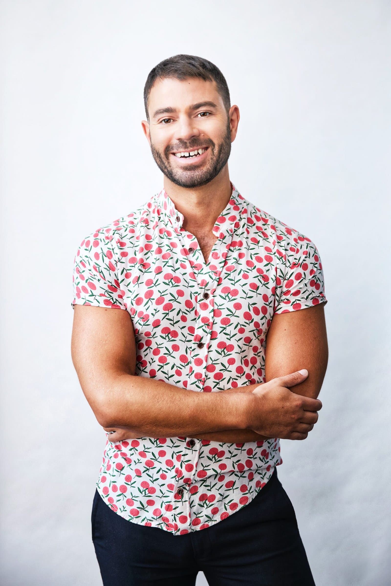 Studio portrait of Michael DiIorio in a tailored dark suit, warm smile.